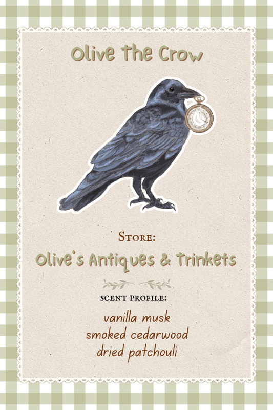 Olive the crow who owns Olive's Antiques and Trinkets which smells like Vanilla Musk, Smoked Cedarwood, and Dried Patchouli.